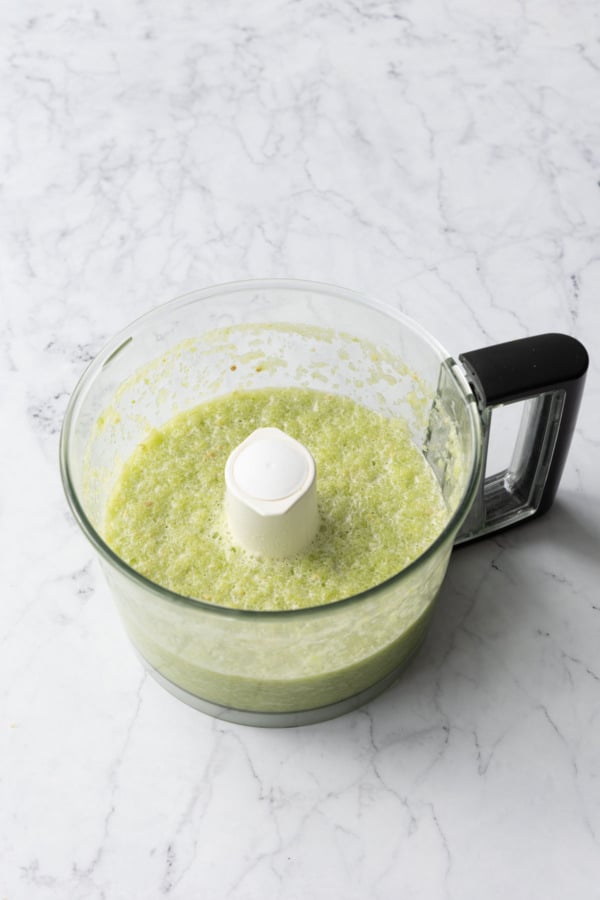 Green tomato puree in a food processor after pureeing until smooth.