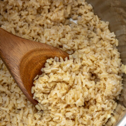 Brown Rice in the instant pot with wooden spoon.