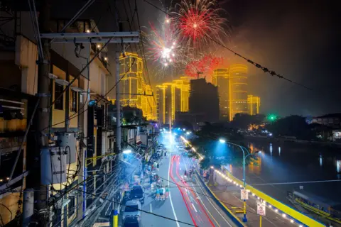 Getty Images Fireworks explode over skyscrapers during New Year celebrations in Makati, Metro Manila, Philippines