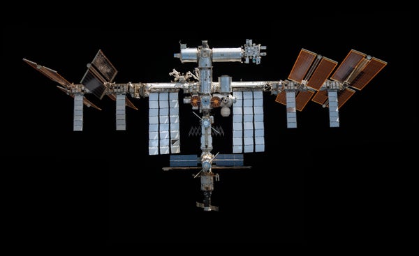 A view of the International Space Station against the blackness of space.